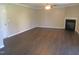 Spacious living room featuring hardwood floors, a ceiling fan, and cozy fireplace, perfect for relaxing at 202 Redstone Ct, Gibsonville, NC 27249