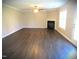 Large living room with hardwood floors, a ceiling fan, and a cozy fireplace with natural light at 202 Redstone Ct, Gibsonville, NC 27249