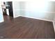 An empty living room featuring dark, glossy hardwood floors, and neutral paint at 202 Redstone Ct, Gibsonville, NC 27249