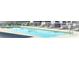 Community pool has lounge chairs and safety equipment, creating a comfortable and secure swimming environment at 202 Redstone Ct, Gibsonville, NC 27249