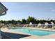 Community pool features a fenced-in area with lounge chairs and meticulously maintained grounds, perfect for relaxation at 202 Redstone Ct, Gibsonville, NC 27249