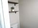 A charming powder room with floating shelves and an adorable potted plant accent at 202 Redstone Ct, Gibsonville, NC 27249