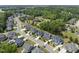 An aerial view showing a residential neighborhood with tree-lined streets and well-maintained homes at 2086 Amalfi Pl, Apex, NC 27502