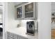 Butler's pantry featuring a built-in coffee station, elegant cabinetry, and granite countertops at 2086 Amalfi Pl, Apex, NC 27502