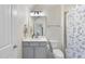 Neat bathroom featuring modern fixtures, cabinetry, and a tub with shower at 2086 Amalfi Pl, Apex, NC 27502