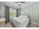 Cozy bedroom featuring neutral colors, natural light, and a ceiling fan at 2086 Amalfi Pl, Apex, NC 27502