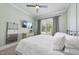 Stylish bedroom with a ceiling fan, a TV and a large window with natural light at 2086 Amalfi Pl, Apex, NC 27502
