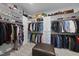Spacious walk-in closet with custom shelving, drawers and a center ottoman at 2086 Amalfi Pl, Apex, NC 27502