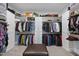 Large walk-in closet with custom shelving, drawers, and ample storage space at 2086 Amalfi Pl, Apex, NC 27502