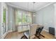 Dining room featuring a wooden table, modern chandelier, large window and light walls at 2086 Amalfi Pl, Apex, NC 27502