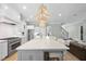 Bright kitchen with a spacious island, stainless steel appliances, and seamlessly connected living area at 2086 Amalfi Pl, Apex, NC 27502