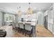 Open kitchen with island seating, white cabinets, modern appliances, and views into the living area at 2086 Amalfi Pl, Apex, NC 27502