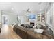 Inviting living room with fireplace, built-ins, ceiling fan, and comfy seating. Staircase in background at 2086 Amalfi Pl, Apex, NC 27502