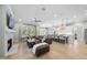 Bright living room with fireplace, TV, built-ins, and open floor plan flowing into kitchen and dining at 2086 Amalfi Pl, Apex, NC 27502