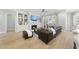 Cozy living room featuring built-in bookshelves, a fireplace, plush seating, and a ceiling fan at 2086 Amalfi Pl, Apex, NC 27502