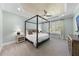 Spacious main bedroom featuring a four-poster bed, tray ceiling, and soft carpeting at 2086 Amalfi Pl, Apex, NC 27502
