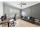 Modern office featuring a comfortable sitting area, natural light, and a wooden desk at 2086 Amalfi Pl, Apex, NC 27502