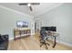 Spacious office with wood floors, TV, stylish furniture, and natural light at 2086 Amalfi Pl, Apex, NC 27502
