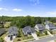 Scenic street view showcasing beautiful homes, mature trees, and well-manicured lawns at 2086 Amalfi Pl, Apex, NC 27502