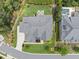 An aerial view of the property showing landscaping, driveway, the pool and backyard at 209 Preston Retreat Ln, Cary, NC 27513