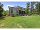 The backyard has a patio with chairs, screened in back porch, and a landscaped yard at 209 Preston Retreat Ln, Cary, NC 27513