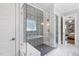 Modern bathroom featuring a glass shower with stylish black and white patterned tile and a built in bench at 209 Preston Retreat Ln, Cary, NC 27513