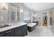 Serene bathroom boasts double vanities, stand alone tub, and an adjacent walk-in closet at 209 Preston Retreat Ln, Cary, NC 27513