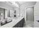 Neutral bathroom featuring modern vanity, stone countertop, and an expansive mirror at 209 Preston Retreat Ln, Cary, NC 27513