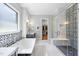 Luxurious bathroom featuring soaking tub, glass enclosed shower and modern finishes at 209 Preston Retreat Ln, Cary, NC 27513
