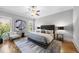 Bright bedroom with stylish ceiling fan, statement artwork and hardwood flooring at 209 Preston Retreat Ln, Cary, NC 27513
