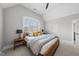 Bright bedroom with a large window and neutral walls and carpet offers a serene retreat at 209 Preston Retreat Ln, Cary, NC 27513