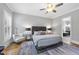 Bedroom featuring ceiling fan, wood floors, and an ensuite bathroom at 209 Preston Retreat Ln, Cary, NC 27513