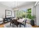 Bright dining room with modern chandelier and large window with a view of the backyard at 209 Preston Retreat Ln, Cary, NC 27513