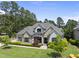Charming two-story home with stone accents, neutral paint, mature trees, and manicured landscaping at 209 Preston Retreat Ln, Cary, NC 27513