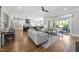 Spacious living room flowing into a modern kitchen with lots of natural light and hardwood floors at 209 Preston Retreat Ln, Cary, NC 27513