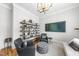 Serene sitting area showcases a bookshelf, comfortable chairs, natural light, and hardwood flooring at 209 Preston Retreat Ln, Cary, NC 27513