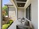 Cozy front porch with stone columns, comfortable seating, and views of a beautifully landscaped yard at 209 Preston Retreat Ln, Cary, NC 27513