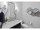 Elegant powder room featuring marble countertop, decorative mirror, and modern lighting at 209 Preston Retreat Ln, Cary, NC 27513