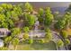 Breathtaking aerial view of a gazebo in a park surrounded by mature trees and a lake in the distance at 210 Presidents Walk Ln, Cary, NC 27519