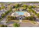 Aerial view of a community clubhouse and pool with surrounding lounge areas, and lush trees at 210 Presidents Walk Ln, Cary, NC 27519