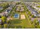 Aerial view showcasing a tennis court and sand volleyball court in a neighborhood at 210 Presidents Walk Ln, Cary, NC 27519