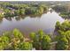 Aerial view of a lake surrounded by lush trees and foliage at 210 Presidents Walk Ln, Cary, NC 27519