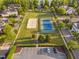 Aerial view showcasing a tennis court and sand volleyball court surrounded by a grassy area at 210 Presidents Walk Ln, Cary, NC 27519