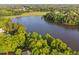 Aerial view of a lake surrounded by lush trees and neighborhood homes at 210 Presidents Walk Ln, Cary, NC 27519