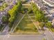 Aerial view of a community park with symmetrical walkways and landscaping in a neighborhood at 210 Presidents Walk Ln, Cary, NC 27519