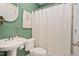 Bright half bathroom with a pedestal sink, toilet, and decorative accents at 210 Presidents Walk Ln, Cary, NC 27519