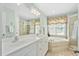 Bathroom with double vanity, jacuzzi tub, and glass shower stall at 210 Presidents Walk Ln, Cary, NC 27519