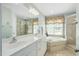 Bathroom with double vanity, jacuzzi tub, and glass shower stall at 210 Presidents Walk Ln, Cary, NC 27519