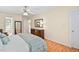 Bright bedroom features wood floors, ceiling fan, and ensuite bathroom at 210 Presidents Walk Ln, Cary, NC 27519