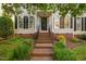 Welcoming front entrance with brick steps, black door with glass, and manicured landscaping at 210 Presidents Walk Ln, Cary, NC 27519